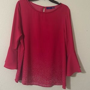 Pink shirt with polka dot detailing on bottom